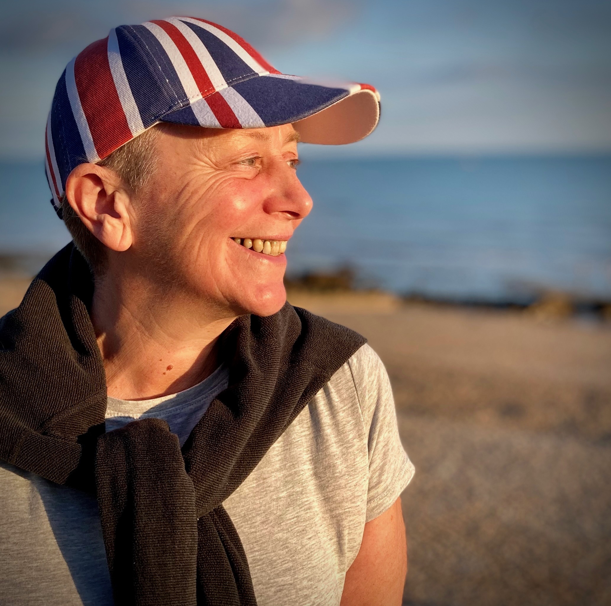Jayne wearing her British cap by the coast